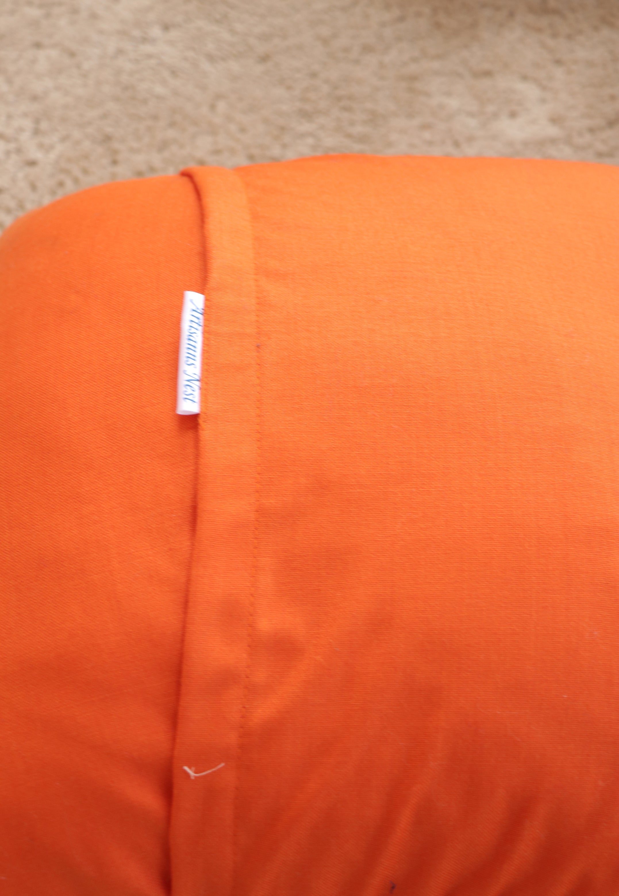 Orange hand knitted cushions with cots-wool backing by artisans of India for winter season
